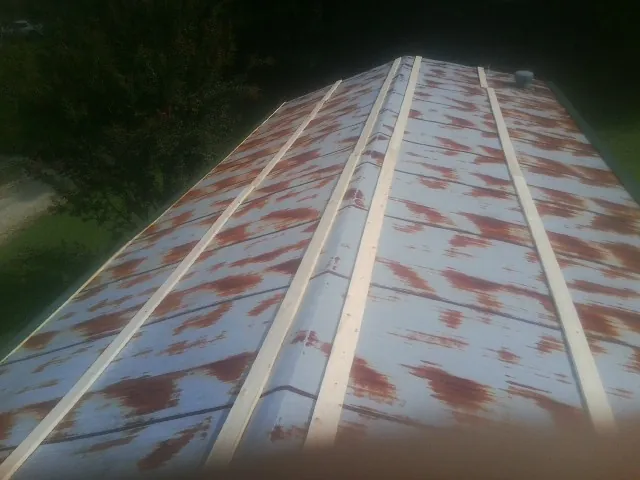 Rusted metal roof panels with new wood purlins before replacement — Storm Damage Roof Repair in Egypt by Roofing Brothers