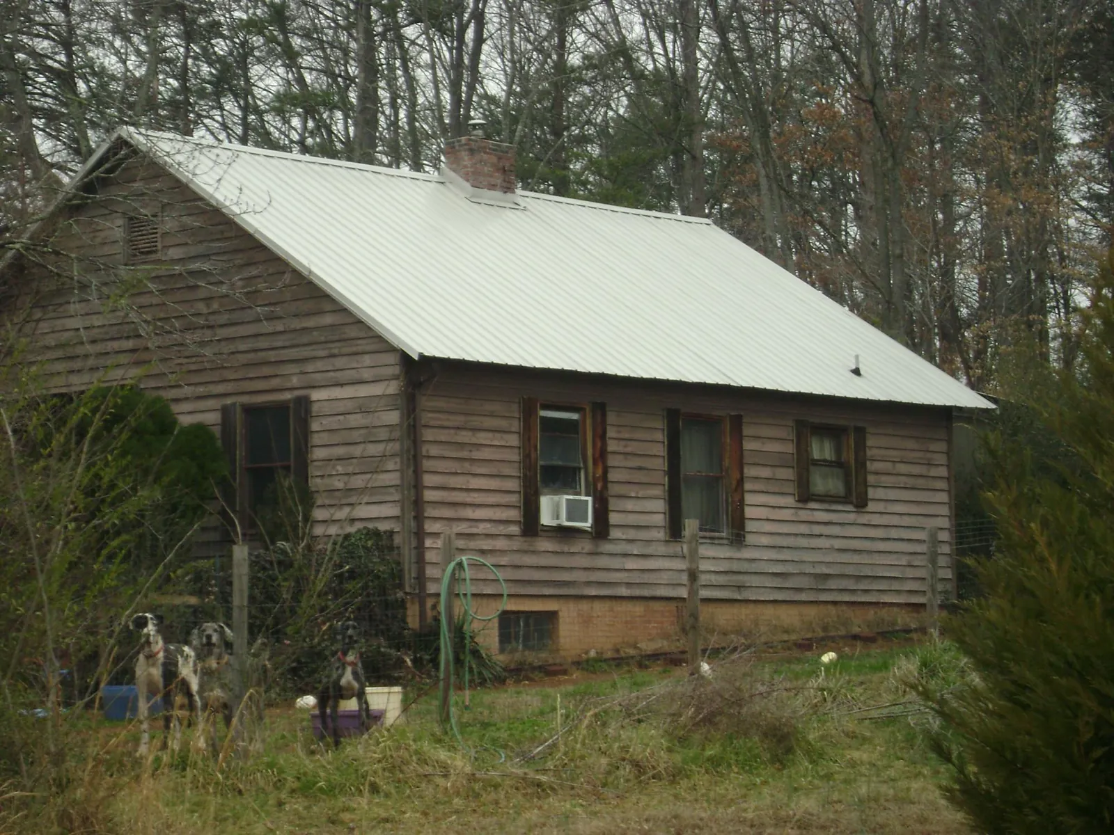 White metal roof on an old wood sided farmhouse, from a Metal Roof Installation job in Egypt
